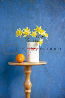 bouquet narcissus in vase and orange fruit