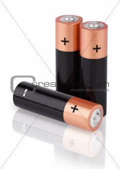 Closeup of three AA batteries on white