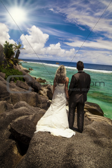 Bride and groom looking out over the ocean