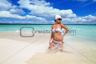 Sexy woman in bikini in ocean surf