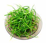 Fresh garlic scapes on plate