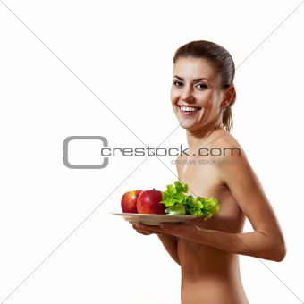 Young woman holding plate with apples and lettuce