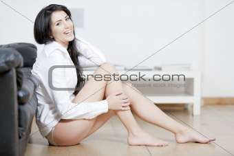 Young woman sat on the floor in sitting room