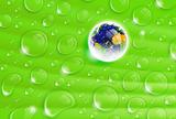 planet Earth inside a dew drop on a green leaf