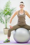 Fitness woman sitting on fitness ball