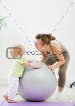 Mother and kid having fun in gym