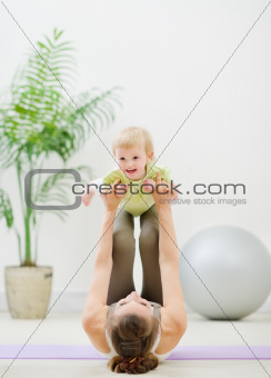 Mother and baby making gymnastics