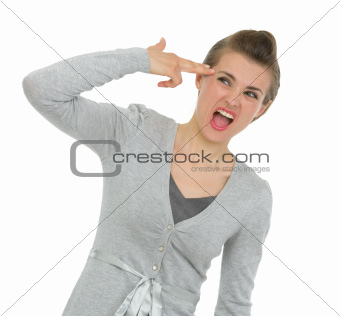 Business woman trying to shoot herself with gun shaped hand