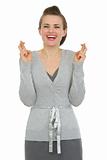 Happy woman employee with crossed fingers