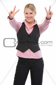 Smiling woman showing victory gesture