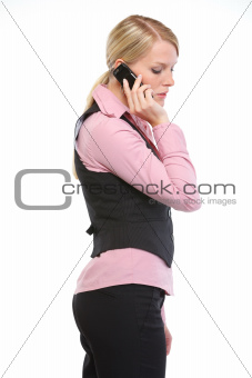 Woman employee speaking mobile phone. Side view