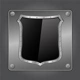 Black shield on metal board