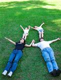 asian family lying on the grass