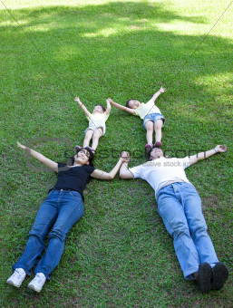 asian family lying on the grass