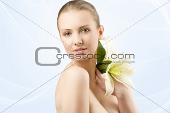 beauty portrait with flowers, she looks in to the lens
