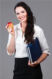 Woman holding books and apple