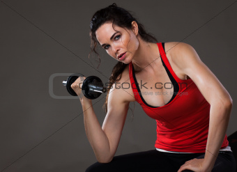 Beautiful woman lifting weights