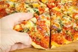 Hand grabbing slize of pizza