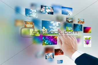men hand using touch screen interface with pictures in frames