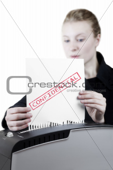 woman shredding a confidential paper