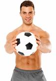 Happy muscular young man holding soccer ball over white