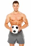 Fit muscular man with soccer ball on white