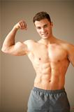 Portrait of muscular sporty man, he shows his biceps