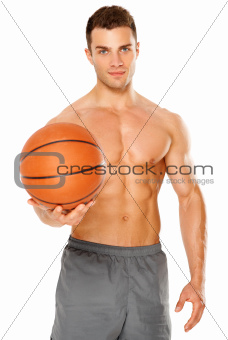 Handsome basketball player holding ball on white