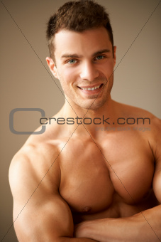 Portrait of smiling man with muscular arms