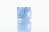 ice cube shot on reflective white surface