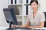 Asian Chinese Woman or Businesswoman Using Computer In Office
