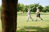 Active senior people jogging in city park