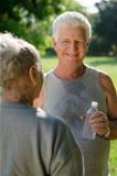 Seniors drinking water after fitness in park
