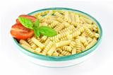 Bowl full of fusilli pasta with tomatoes and basil