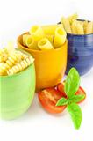 Fusilli, rigatoni and pens pasta in a green, blue and orange jar