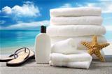 Lotion  towels and sandals with ocean scene