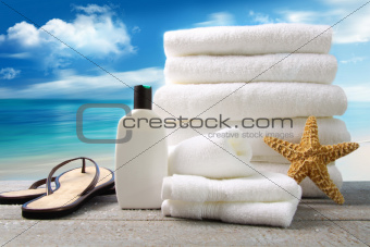 Lotion  towels and sandals with ocean scene