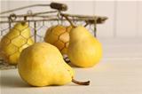 Fresh ripe pears in basket on table