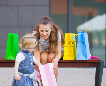 Mother and baby examines purchases after shopping