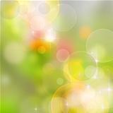 A bright spring background with green and pink bokeh effects
