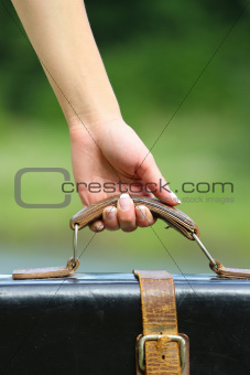 woman's hand with a suitcase