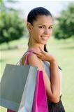 happy young woman smiling with shopping bags