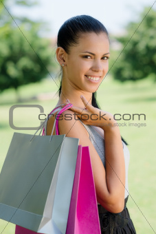 happy young woman smiling with shopping bags