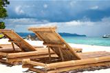 Wooden deck chairs on beach