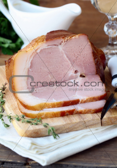Baked ham served with salad and herbs