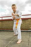 judoka teen boy training judo on the sky background
