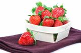 The composition of the strawberries in a basket.