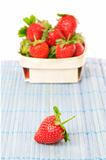 Strawberries in a basket. On a white background.