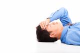 business man lying on floor with headache