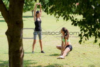 Sports, pretty female friends relaxing after jogging